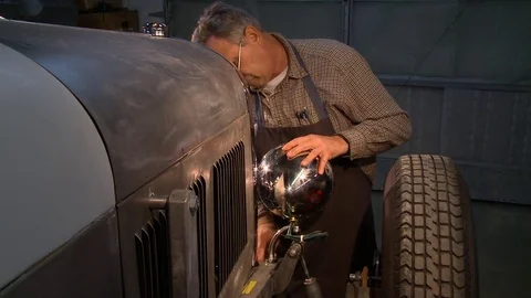 Installing a headlight on a classic hot rod Stock Footage 74129995