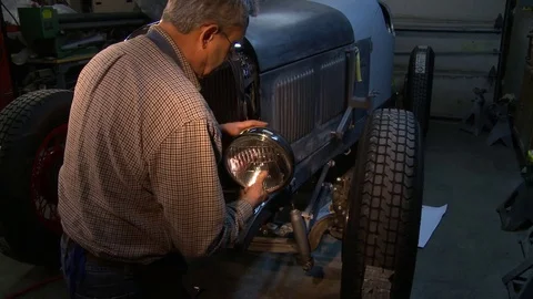 Installing the headlight on a classic hot rod Stock Footage 74130015