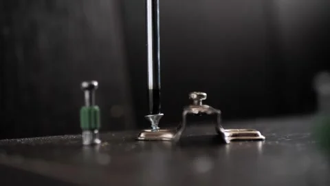 Installing hinges on a furniture door using a Phillips screwdriver. Stock Footage 286140283