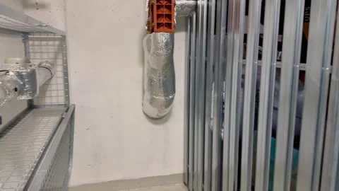 Installing industrial ductwork in a modern building is crucial for efficiency Stock Footage 303783903