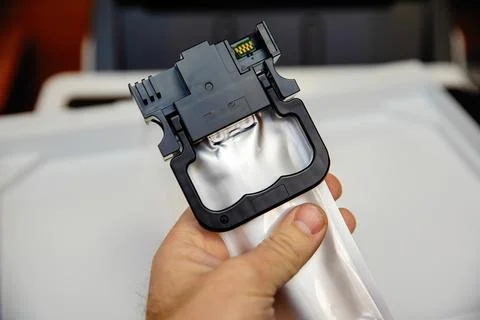 Installing an ink container in an inkjet printer. Stock Photos