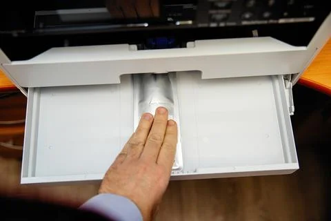 Installing an ink container in an inkjet printer. Stock Photos
