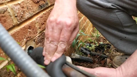 Installing Insulation on Air Conditioner Line Set for Energy Efficiency Stock Footage 332721762