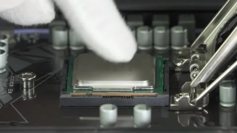   Installing Intel Central processor CPU to socket  on Motherboard. Editorial Stock Footage 149898035