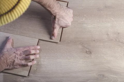 Installing laminate flooring in a room or office. Wooden parquet boards in the Stock Photos