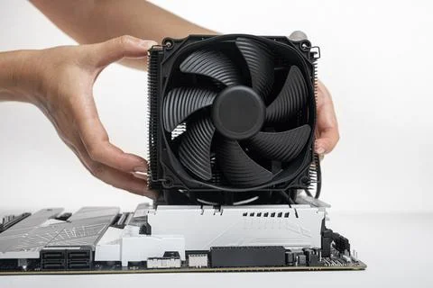 Installing a large cooler on a computer processor. 写真素材