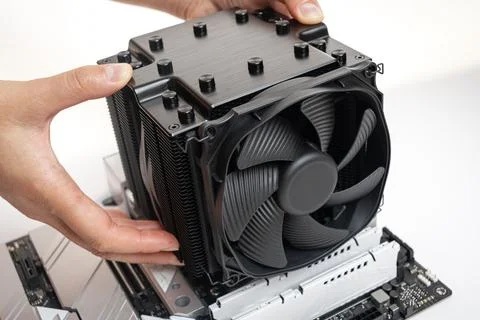 Installing a large cooler on a computer processor. Stock Photos