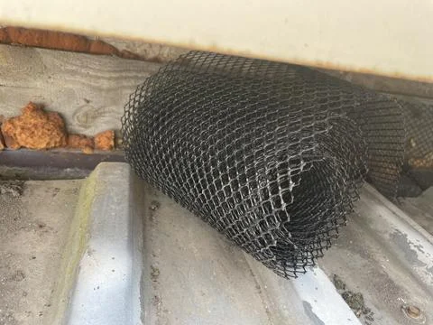 Installing leaf guard mesh in gutter Stock Photos