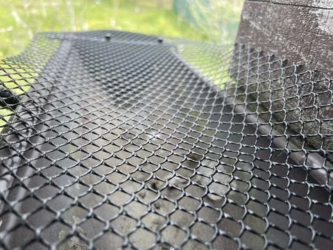 Installing leaf guard mesh in gutter Stock Photos