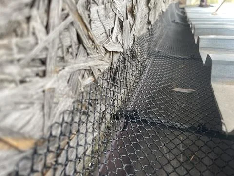Installing leaf guard mesh in gutter Stock Photos