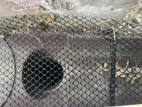 Installing leaf guard mesh in gutter Stock Photos