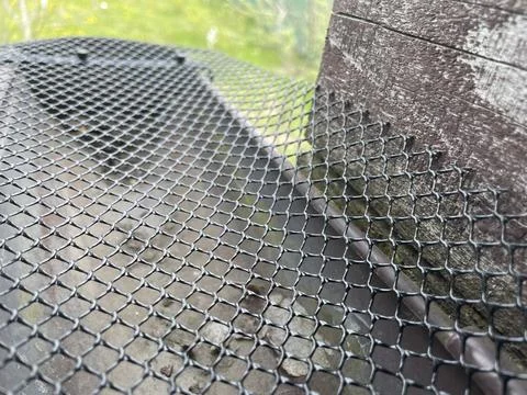 Installing leaf guard mesh in gutter Stock Photos