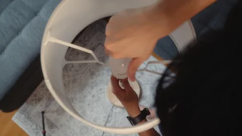 Installing Light Bulb into Floor Lamp Socket Stock Footage 342323791
