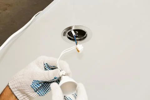 Installing a light bulb in the socket. Stock Photos