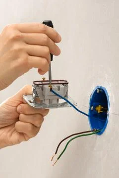 Installing light switch with screwdriver Stock Photos