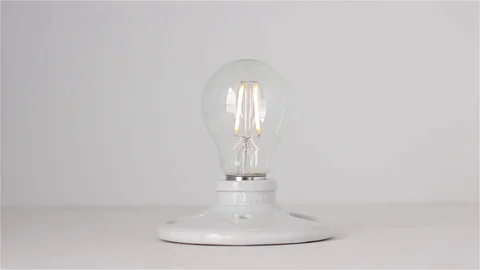 Installing Lightbulb To Bright White Transition Stock Footage 75452931