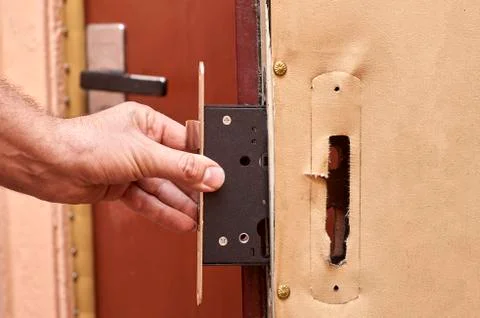 Installing a lock in old door close up Foto stock