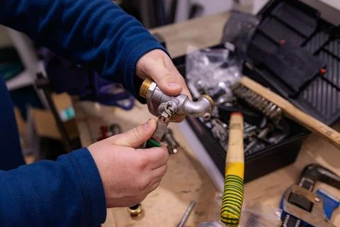 Installing Metal Pipe Connector Fitting by Hand, Plumbing Assembly Work with Thr Stock Photos