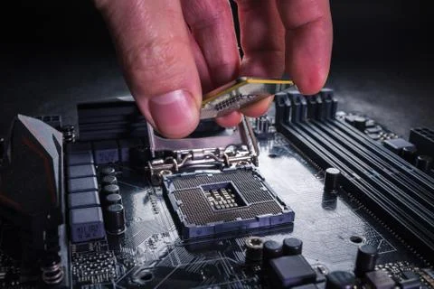 Installing modern central processor unit into motherboard. Copmputer CPU upgrade Stock Photos
