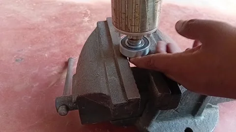 Installing Motor Bearings Manually Using Hammer And Vise 動画素材 334335501
