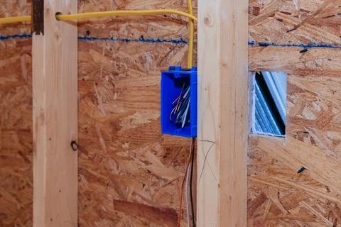 Installing mounting wiring in wall electric box for socket in a new house Stock Photos
