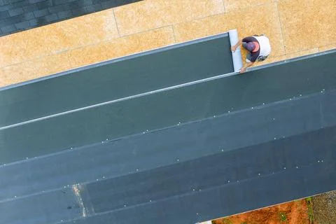 Installing new asphalt bitumen shingles on a home roof Stock Photos
