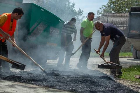 Installing new asphalt surface on a road Stock Photos