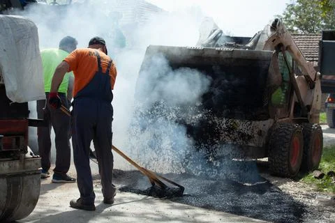 Installing new asphalt surface on a road Stock Photos