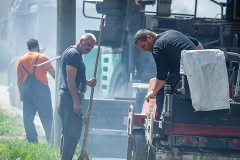 Installing new asphalt surface on a road Stock Photos