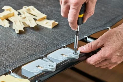 Installing new bed slat holders instead of broken ones 写真素材