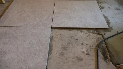 Installing new ceramic tiles on concrete floor Stock Photos