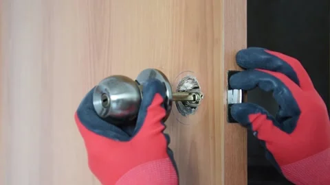 Installing a new door handle in the old hole. Stock Footage 151136253
