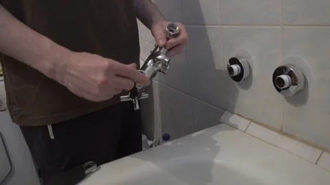 Installing a new faucet in the bathroom Stock Footage 108307415
