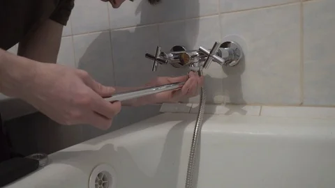 Installing a new faucet in the bathroom Stock Footage 108308097