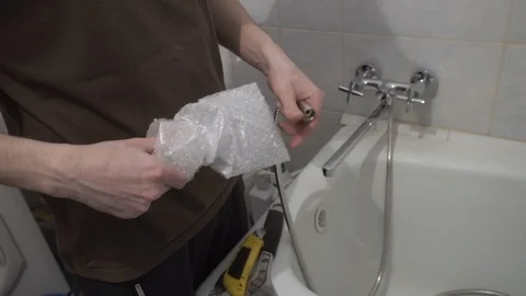 Installing a new faucet in the bathroom Stock Footage 108308267