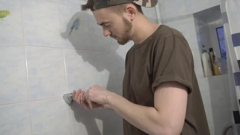 Installing a new faucet in the bathroom Stock Footage 108308393