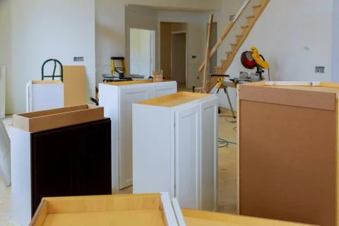 Installing new induction hob in modern kitchen installation of kitchen cabine Stock Photos