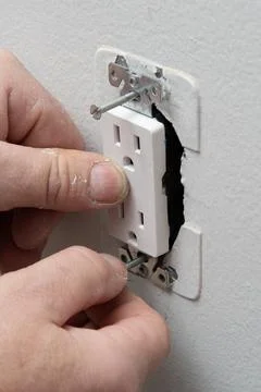Installing a new outlet on the wall Stock Photos