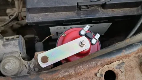 Installing a new red horn on car Stock Footage 296100512