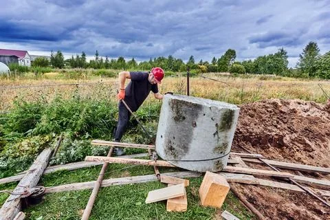 Installing overflow septic tank made of reinforced concrete rings, moving r.. Stock Photos