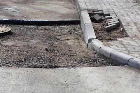 Installing paver bricks on patio during construction works and road repair Stock Photos