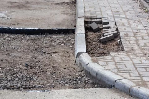 Installing paver bricks on patio during construction works and road repair Stock Photos