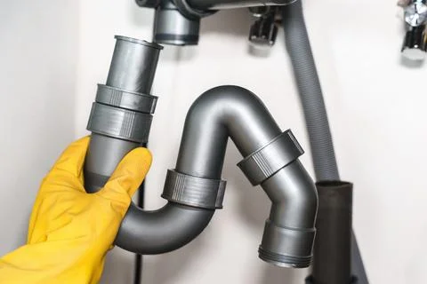 Installing Plastic Sink Trap During Plumbing Repair Stock Photos