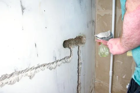 Installing the plastic socket box into the wall. Wiring repair and replacemen Stock Photos