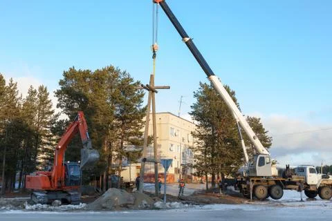 Installing a power pole with the use of special equipment Stock Photos