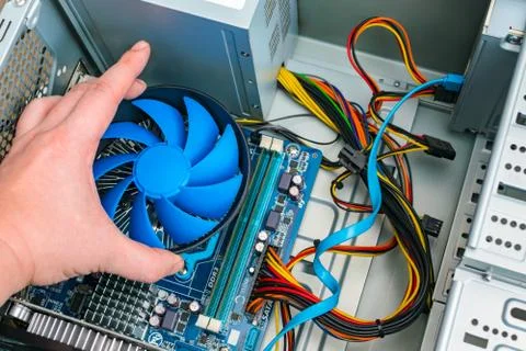 Installing a processor fan on the computer motherboard Stock Photos