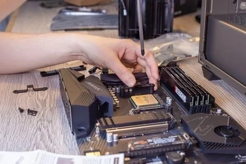 Installing a processor fan on the computer motherboard Stock Photos