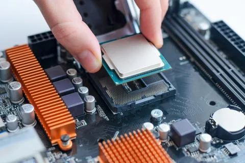 Installing the processor in the motherboard socket. Stock Photos