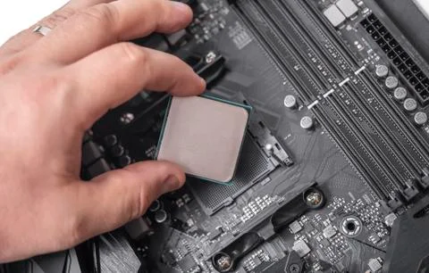Installing processor unit into computer motherboard. Stock Photos