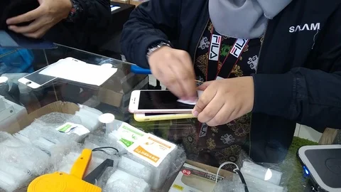  installing a protective glass on the screen of a smartphone.  Stock Footage 105999898